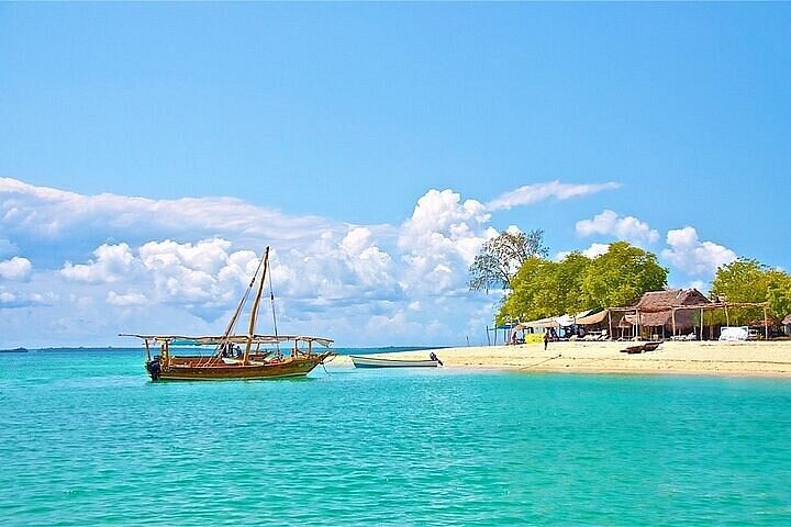 Dhow near sandbank with beach huts